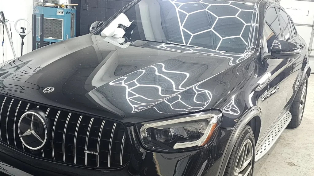 Ceramic coating care on a black Mercedes-AMG GLC with hexagon light reflections