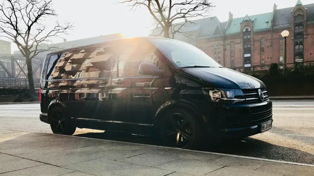 Black work van ready for fleet wraps on a city street