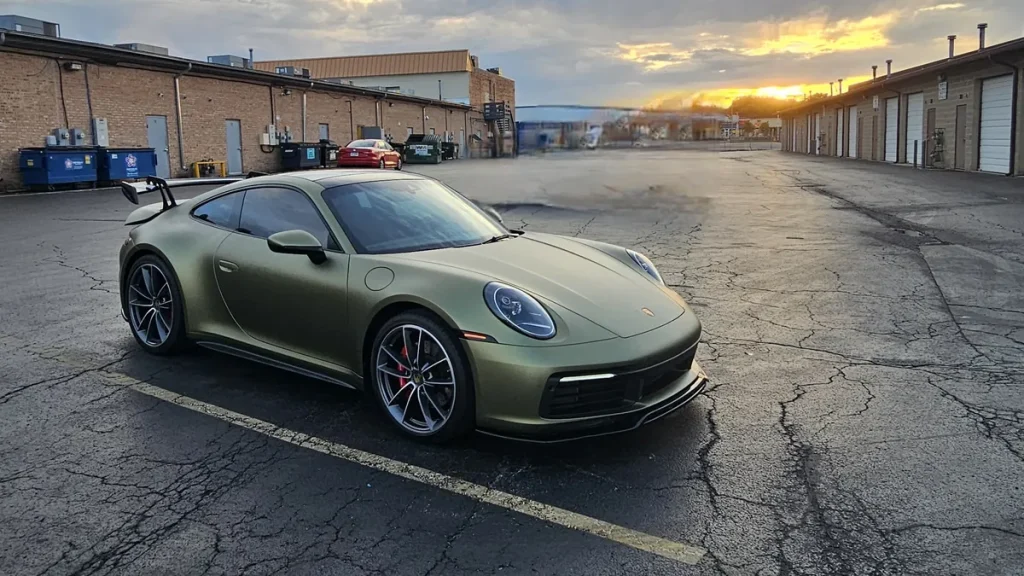 Wrap care for a satin green Porsche 911 color-change wrap at sunset