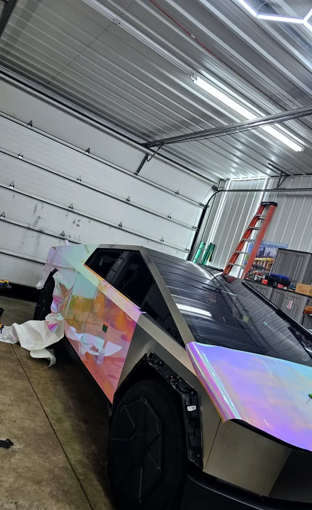 Installer applying color-shift wrap film to a Tesla Cybertruck