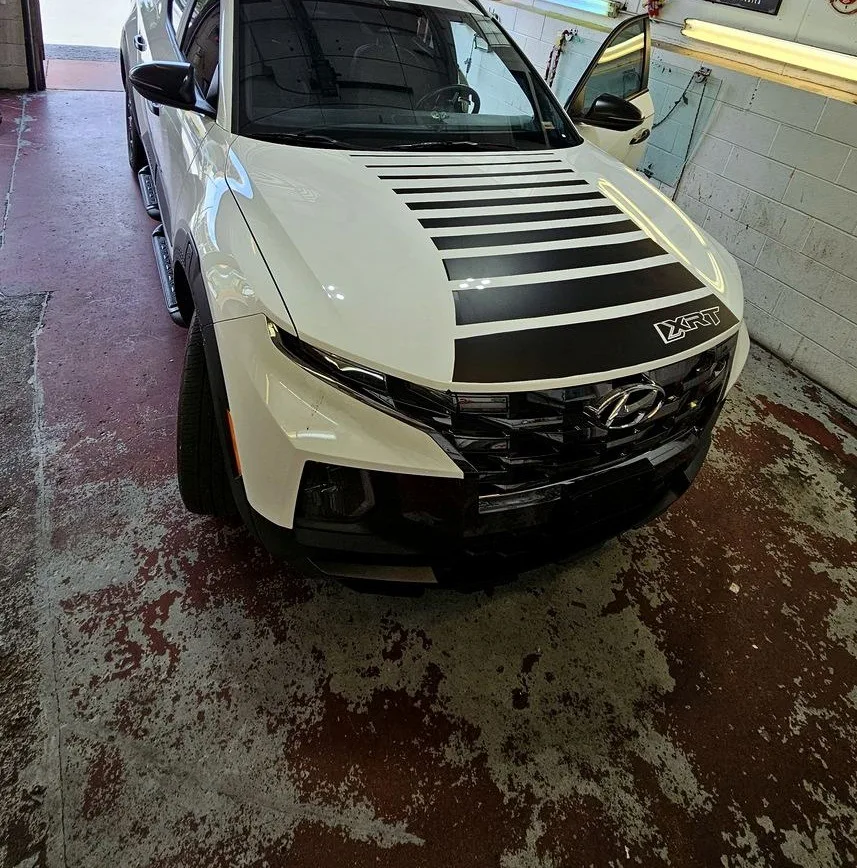 Black hood stripe vinyl graphics on a white SUV