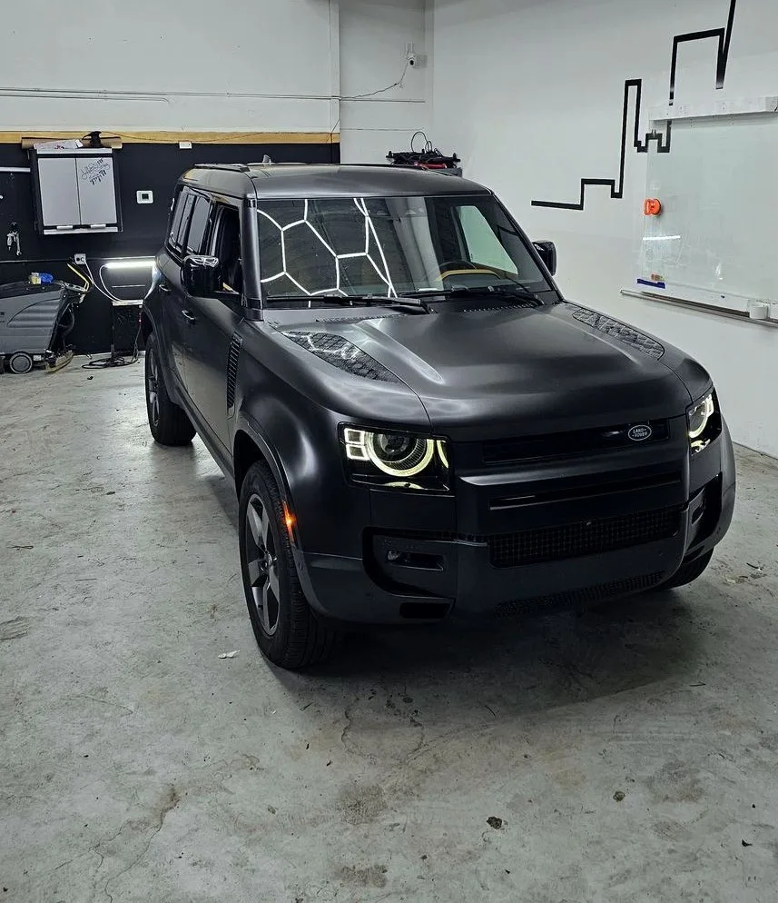 Land Rover Defender in a matte black vinyl wrap