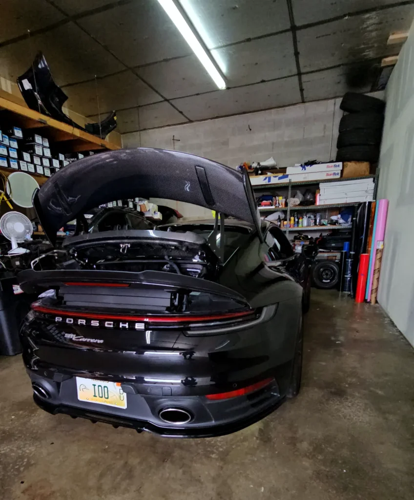 Porsche 911 with the engine lid open during mechanical service