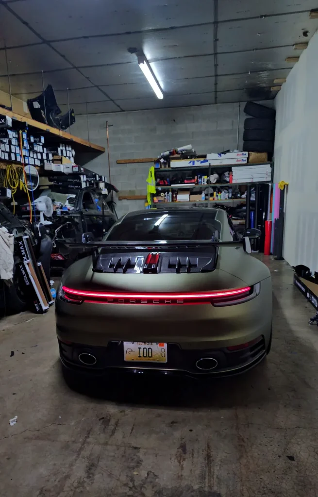 Finished satin green Porsche 911 wrap, rear view with light bar