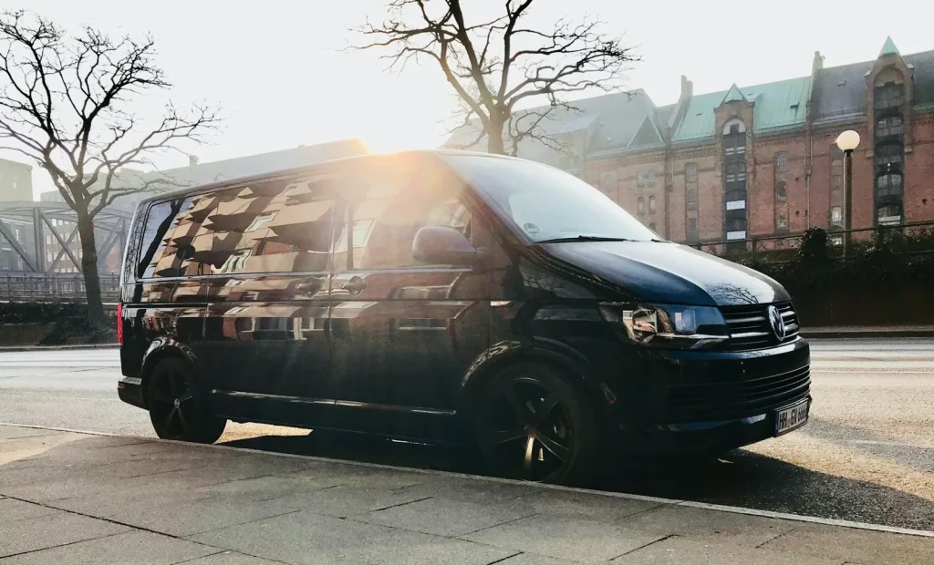 Black commercial van with a geometric wrap design