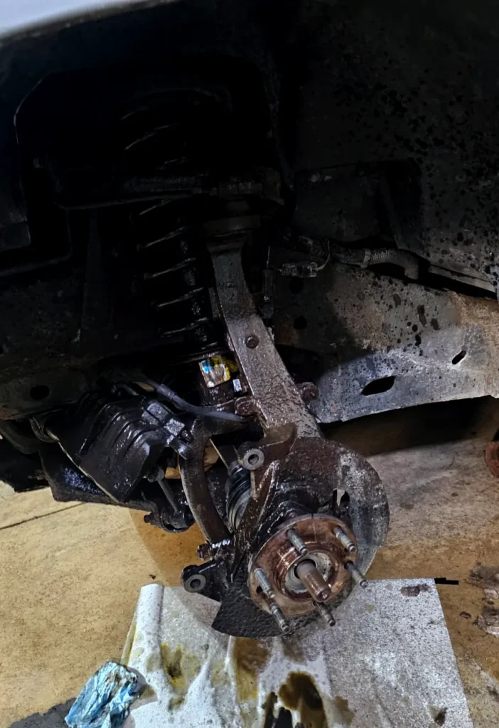 Front suspension and hub assembly during a suspension repair