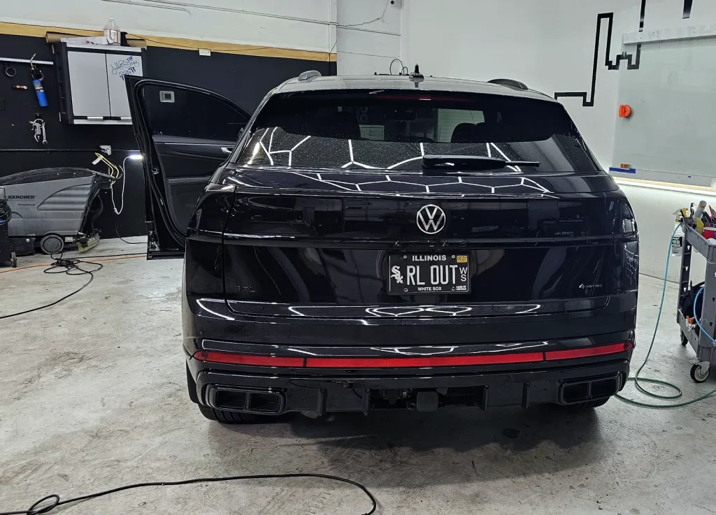 Black Volkswagen Atlas in the paint protection film installation bay